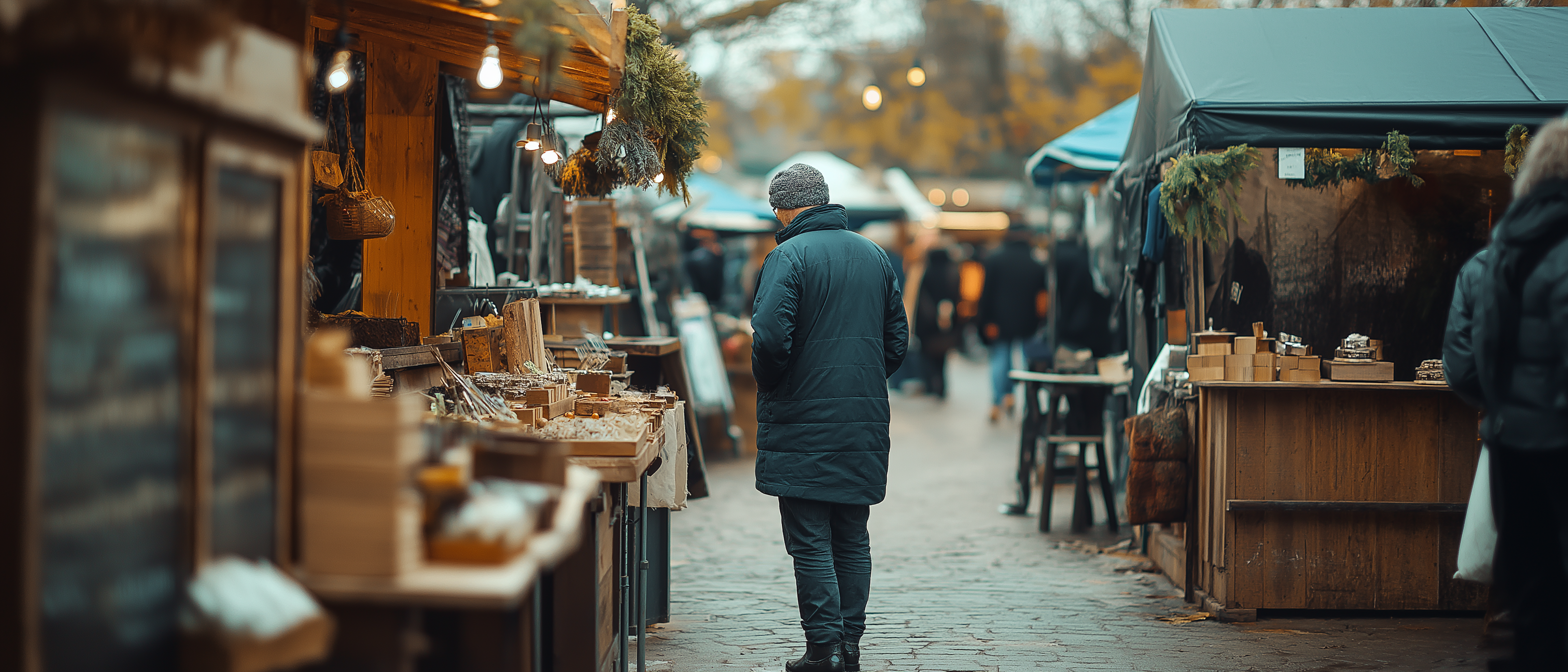 Whats on in East Cambs - Ely Markets - image of shopper at market with soft focus on nearby stalls