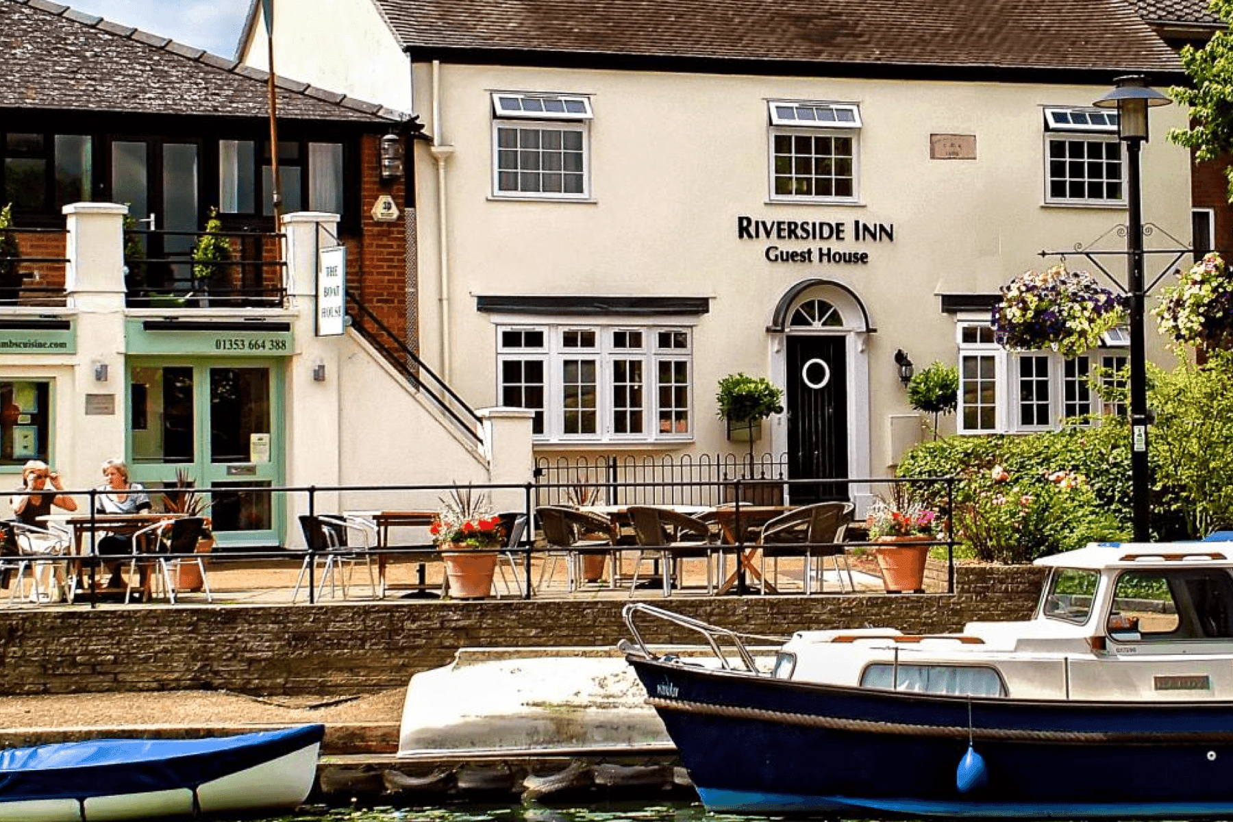 Places to stay in East Cambridgeshire - Exterior of Riverside Inn guest house with boats on water outside